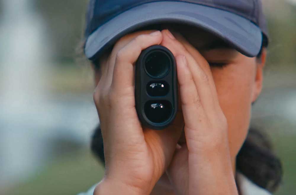 golfer looking through rangefinder