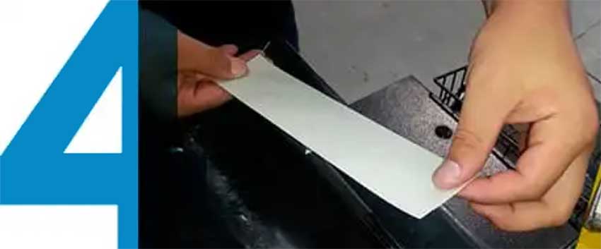 tech applying tape to golf shaft