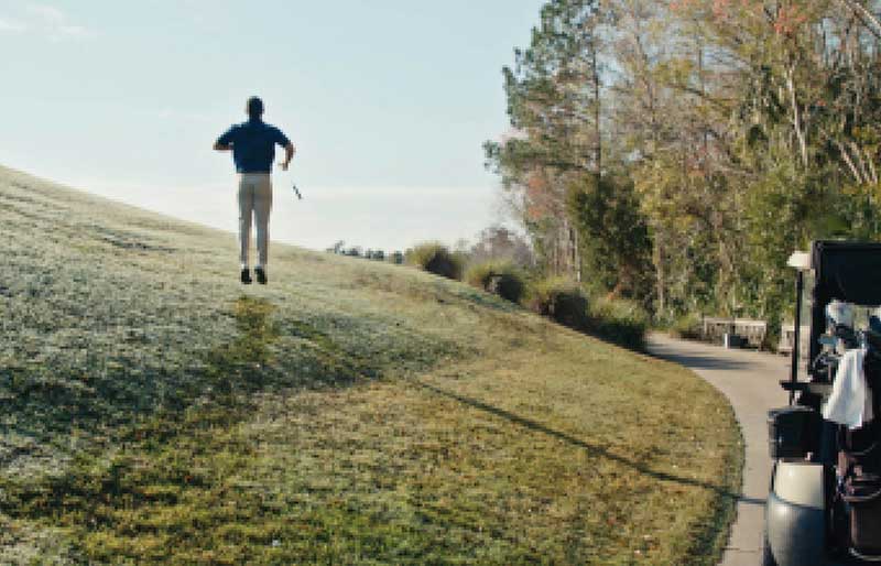 golfer jumping on the green