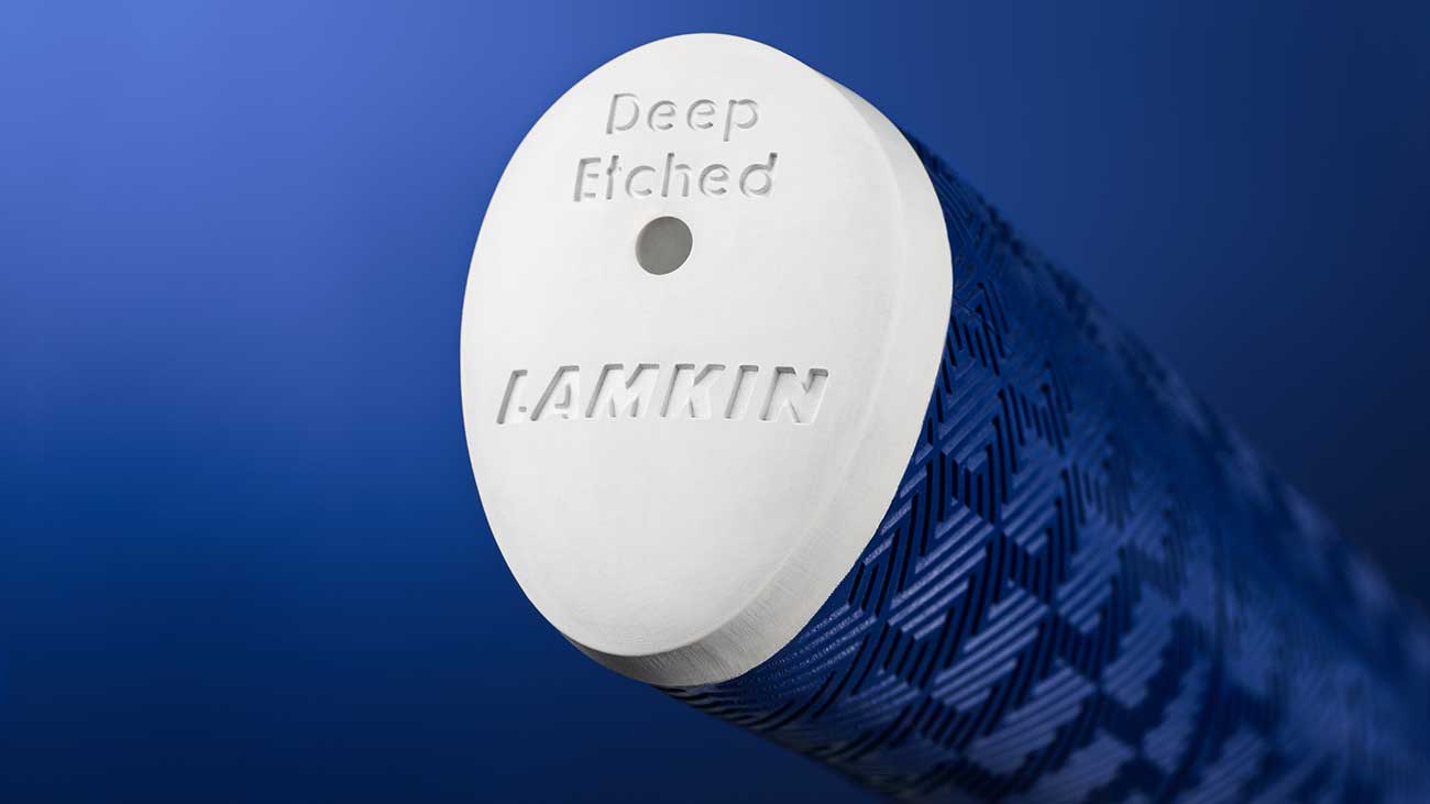 closeup of the end cap of a Deep Etched Sink Fit putter grip in blue from Lamkin Golf Grips